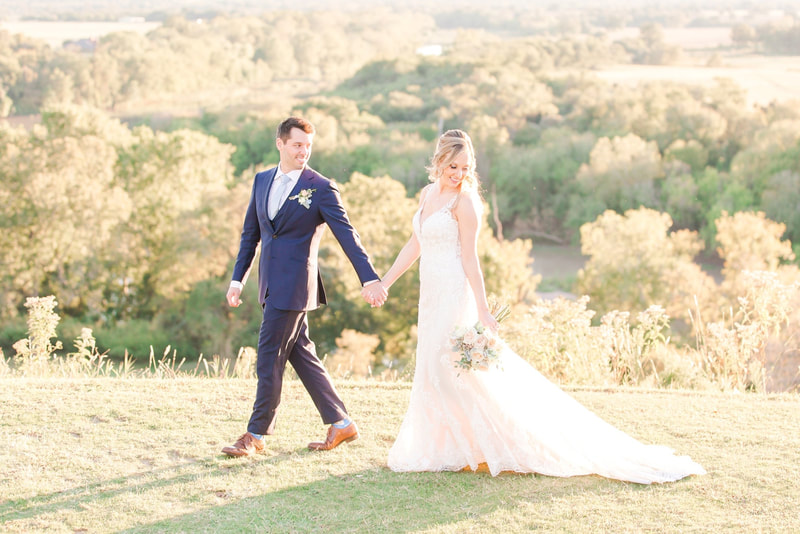 The best wedding to have in the Hillcountry is at The Mansion at ColoVista. Bride and groom walk along the hillside buff.